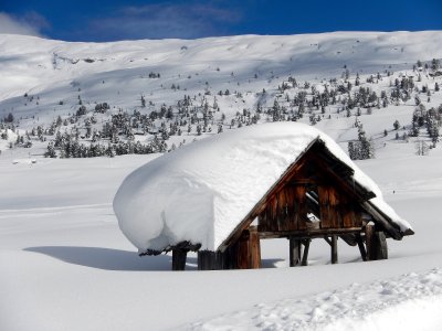 Dolomites and hutes deeply snow covered